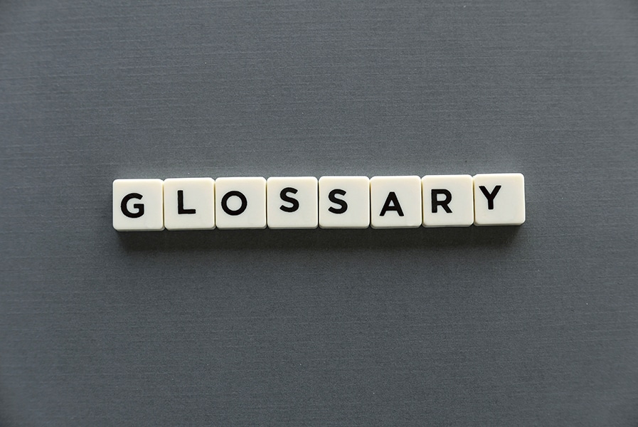 Glossary word made of square letter word on grey background.